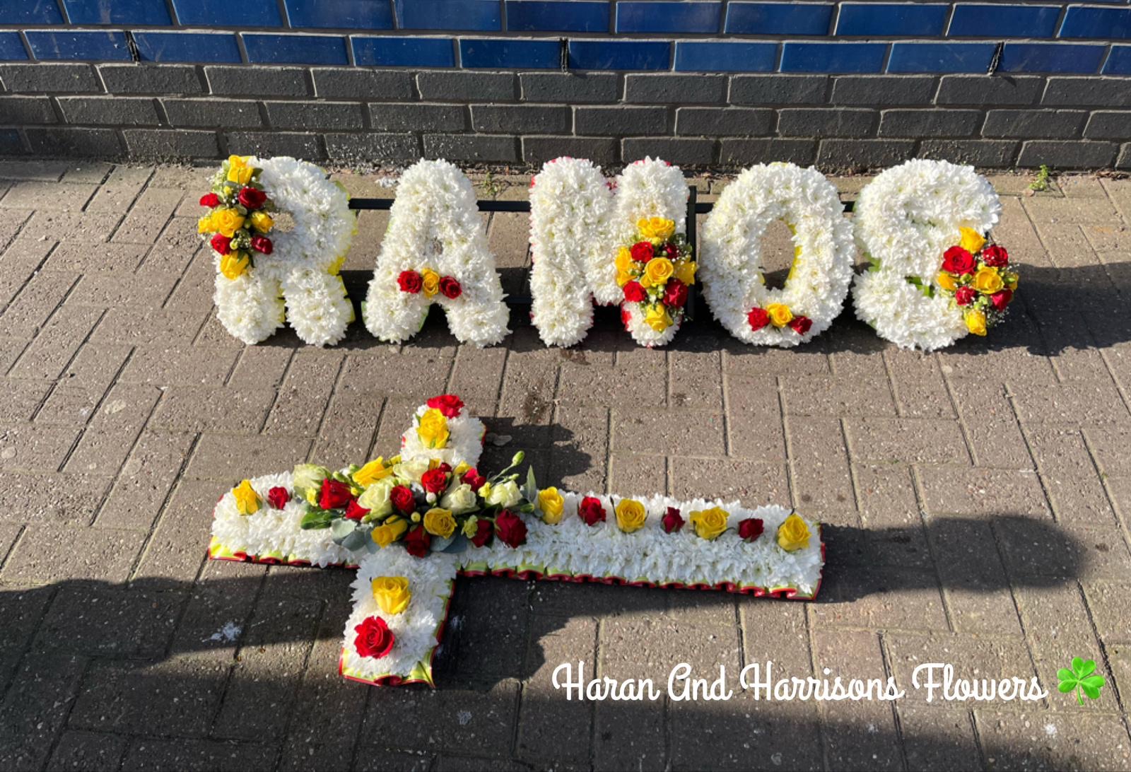 Funeral tributes including lettering and a cross arrangement