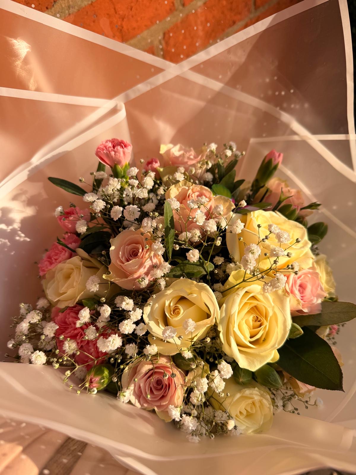 Pastel mixed bouquet of roses, gypsophila and foliage
